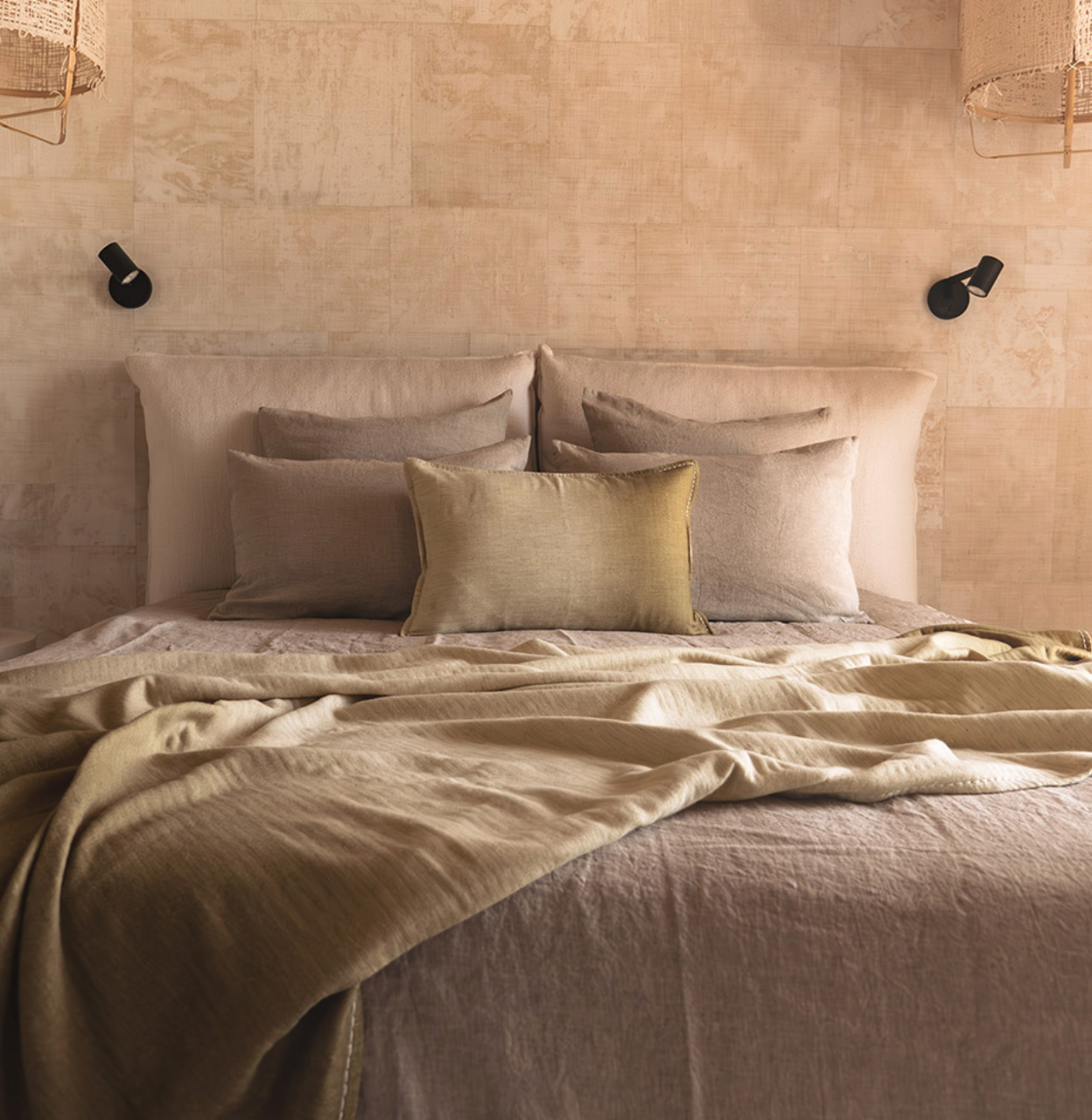 coussins dégradé vert  sur lit drap tons rosés.